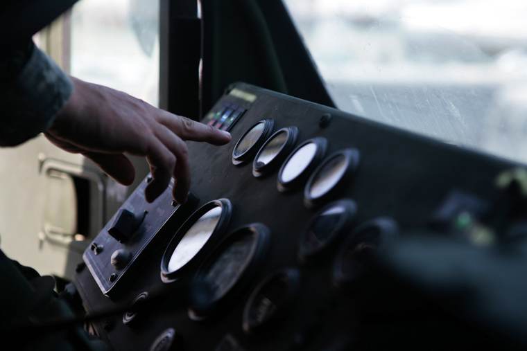 Technician checking a heavy truck gauge panel